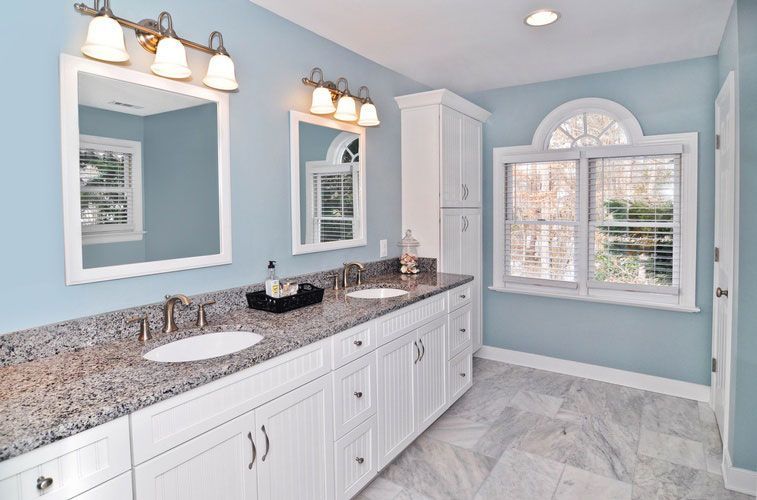 A bathroom with two sinks and two mirrors
