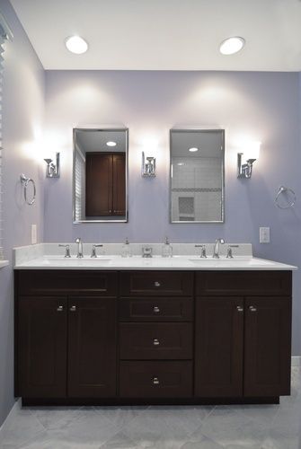 A bathroom with two sinks and two mirrors.