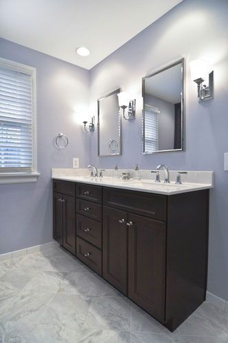 A bathroom with two sinks and two mirrors.