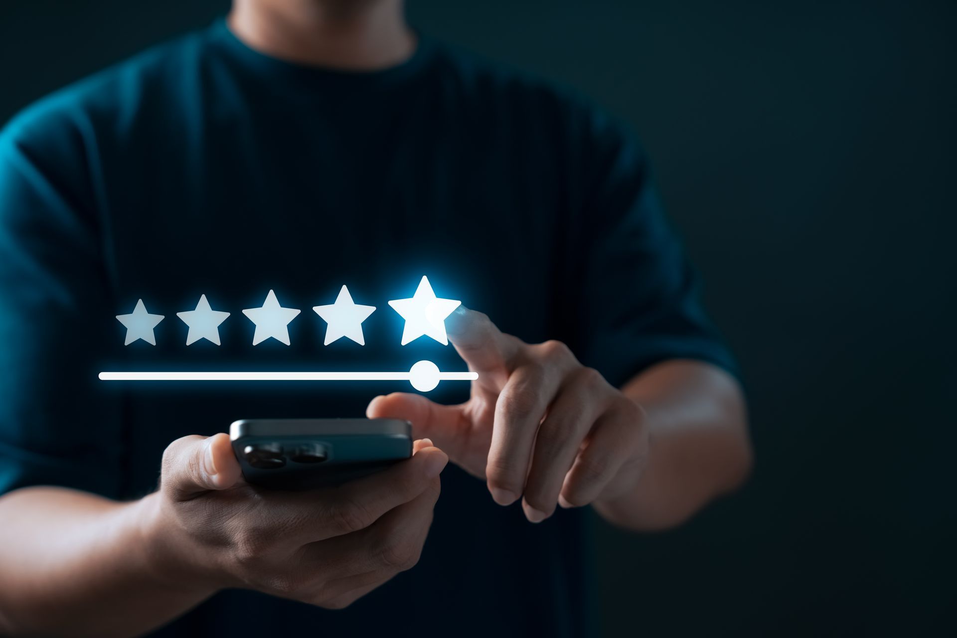 Person giving a five-star rating on a smartphone screen, against a dark background. Person giving a five-star rating on a smartphone screen, against a dark background.