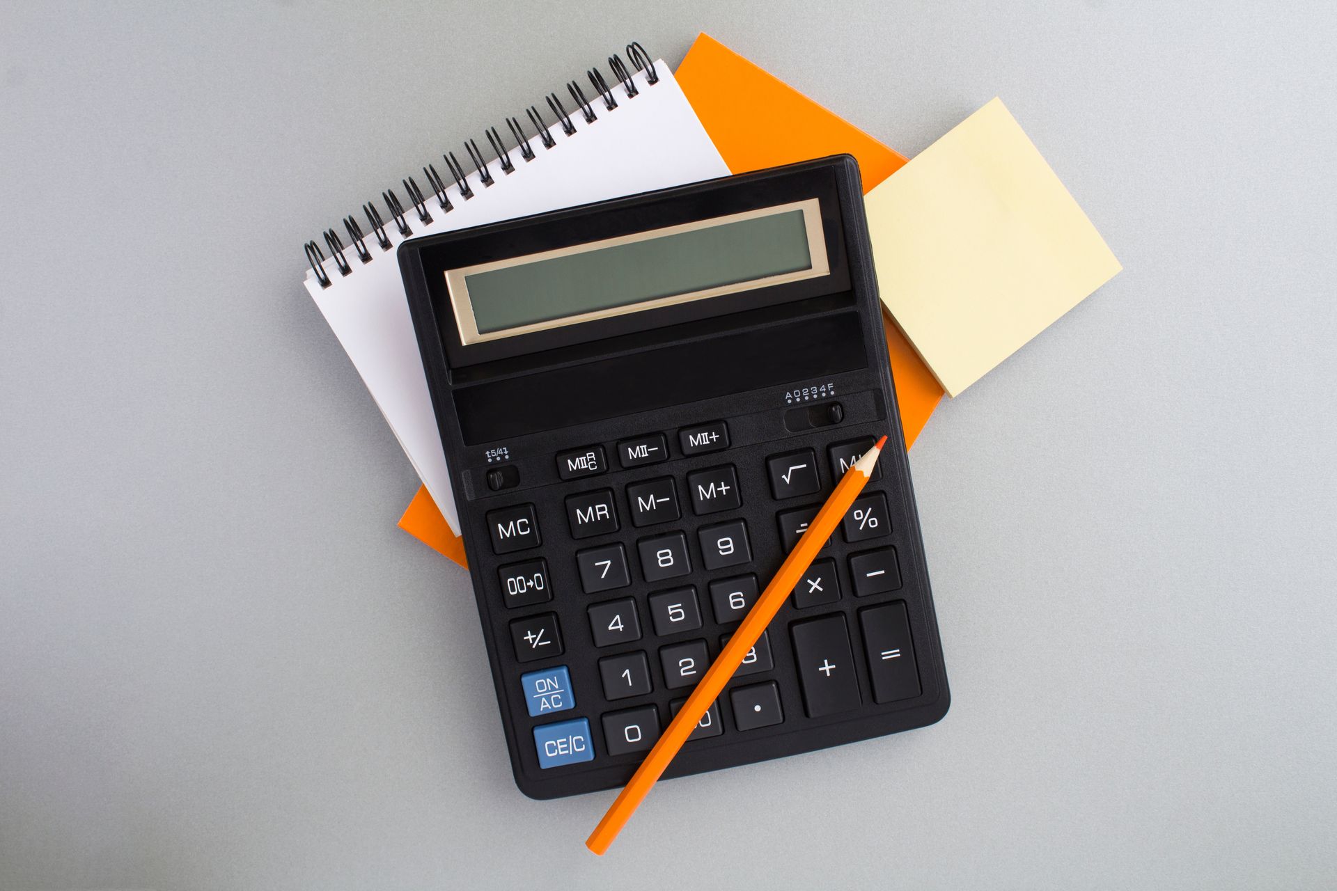 Black calculator with pencil on notebook and sticky notes. Black calculator with pencil on notebook and sticky notes.