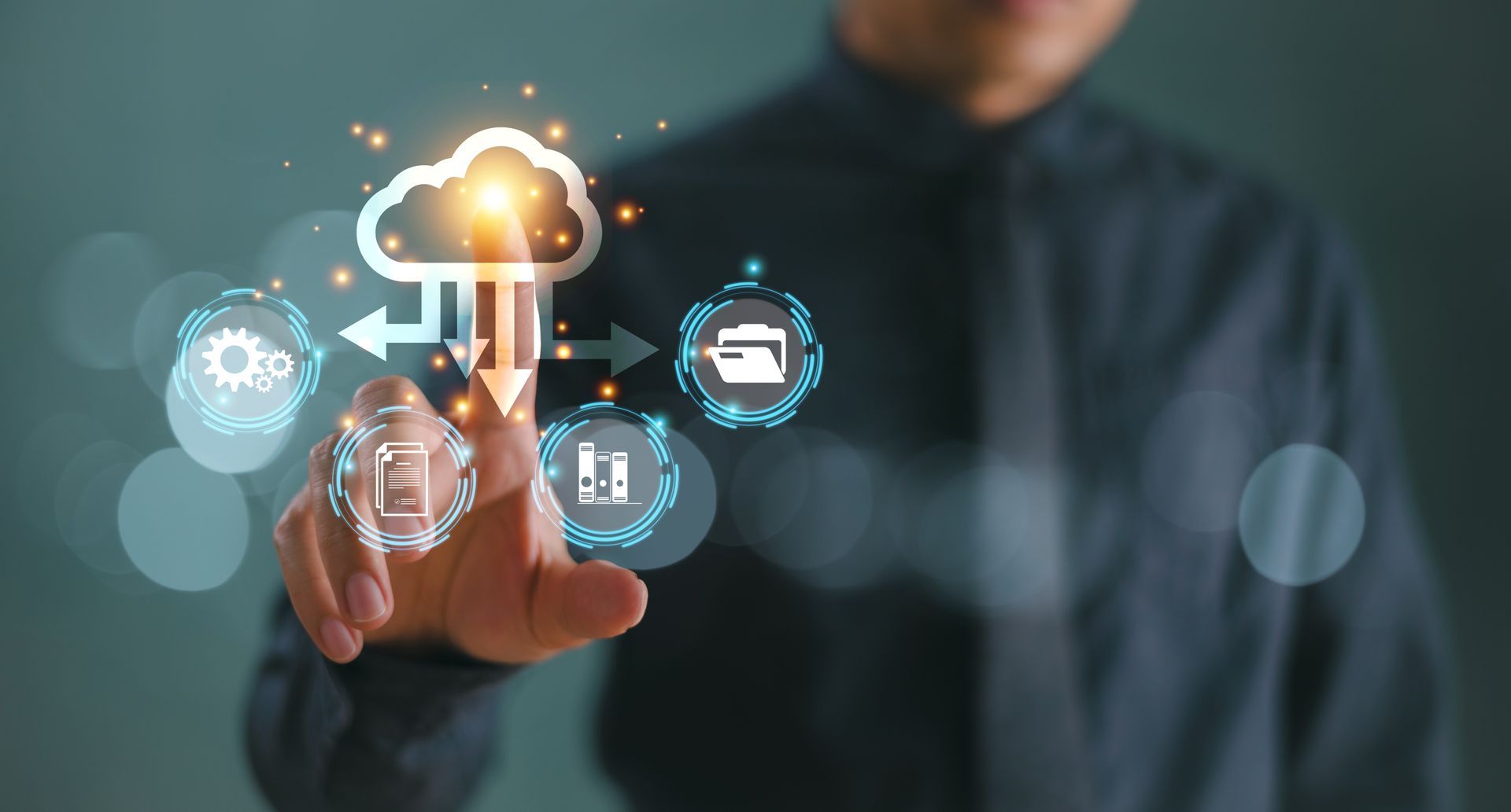 Person touching glowing cloud computing icons on a dark background Person touching glowing cloud computing icons on a dark background