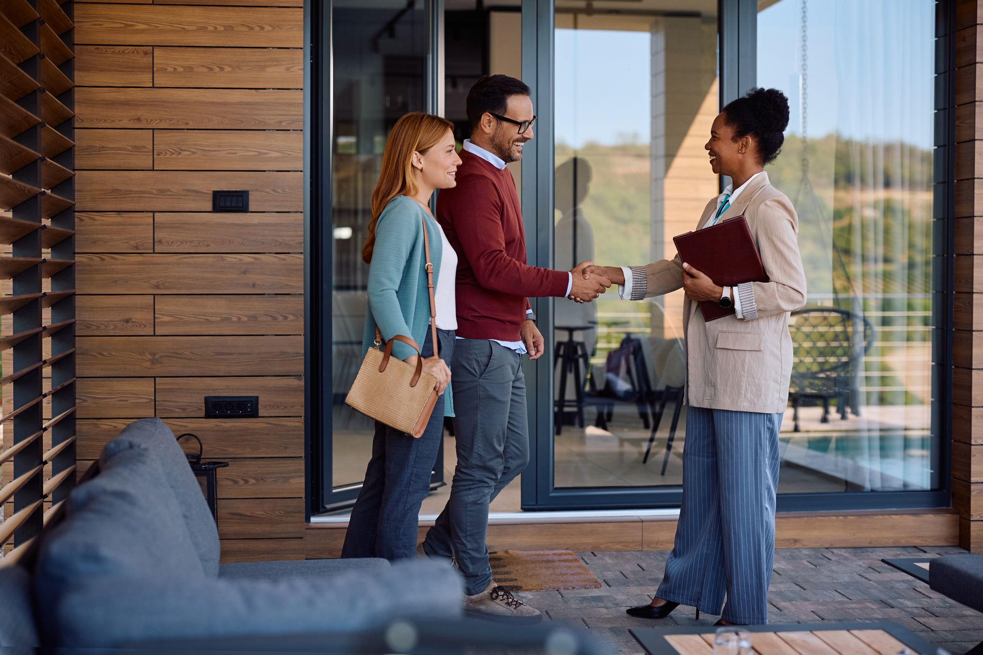 A young couple is meeting with a real estate agent.