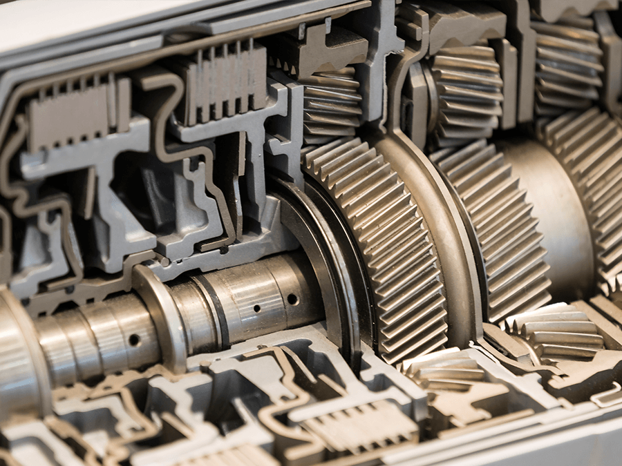 Close-up of interlocking metal gears and shafts in a mechanical cross-section
