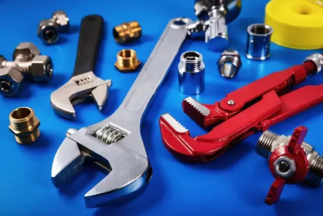 Plumbing tools and parts arranged, highlighting plumbing contractors skills and services. Plumbing tools and parts arranged, highlighting plumbing contractors skills and services.