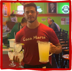 a man wearing a red shirt that says casa maria