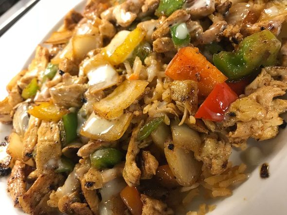 a close up of a plate of food with meat and vegetables on a table .