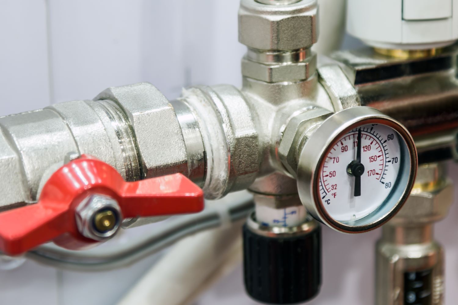 A Close up Of a Valve and A Pressure Gauge on A Pipe — Coffs Coast Plumbing in Korora, NSW