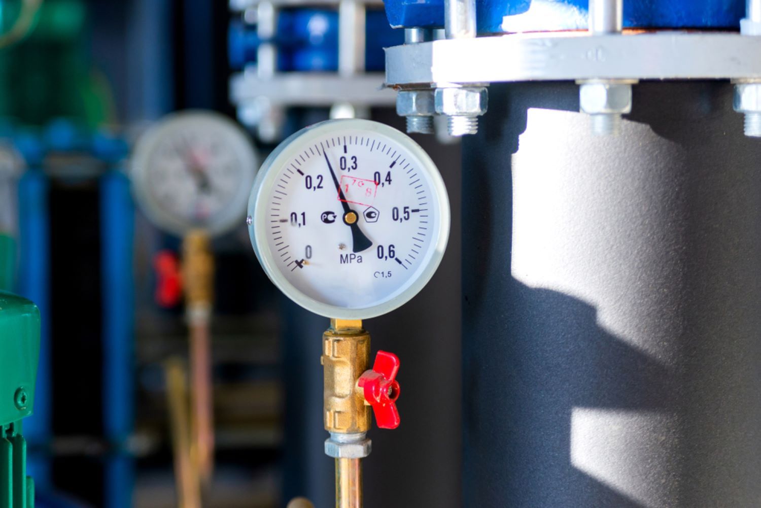 A Close up Of a Pressure Gauge on A Pipe in A Factory — Coffs Coast Plumbing in Korora, NSW