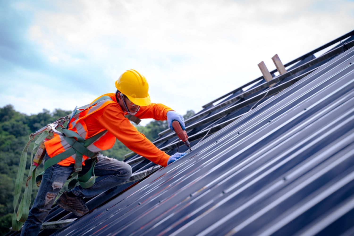 A Man Is Working on The Roof of A Building — Coffs Coast Plumbing in Korora, NSW