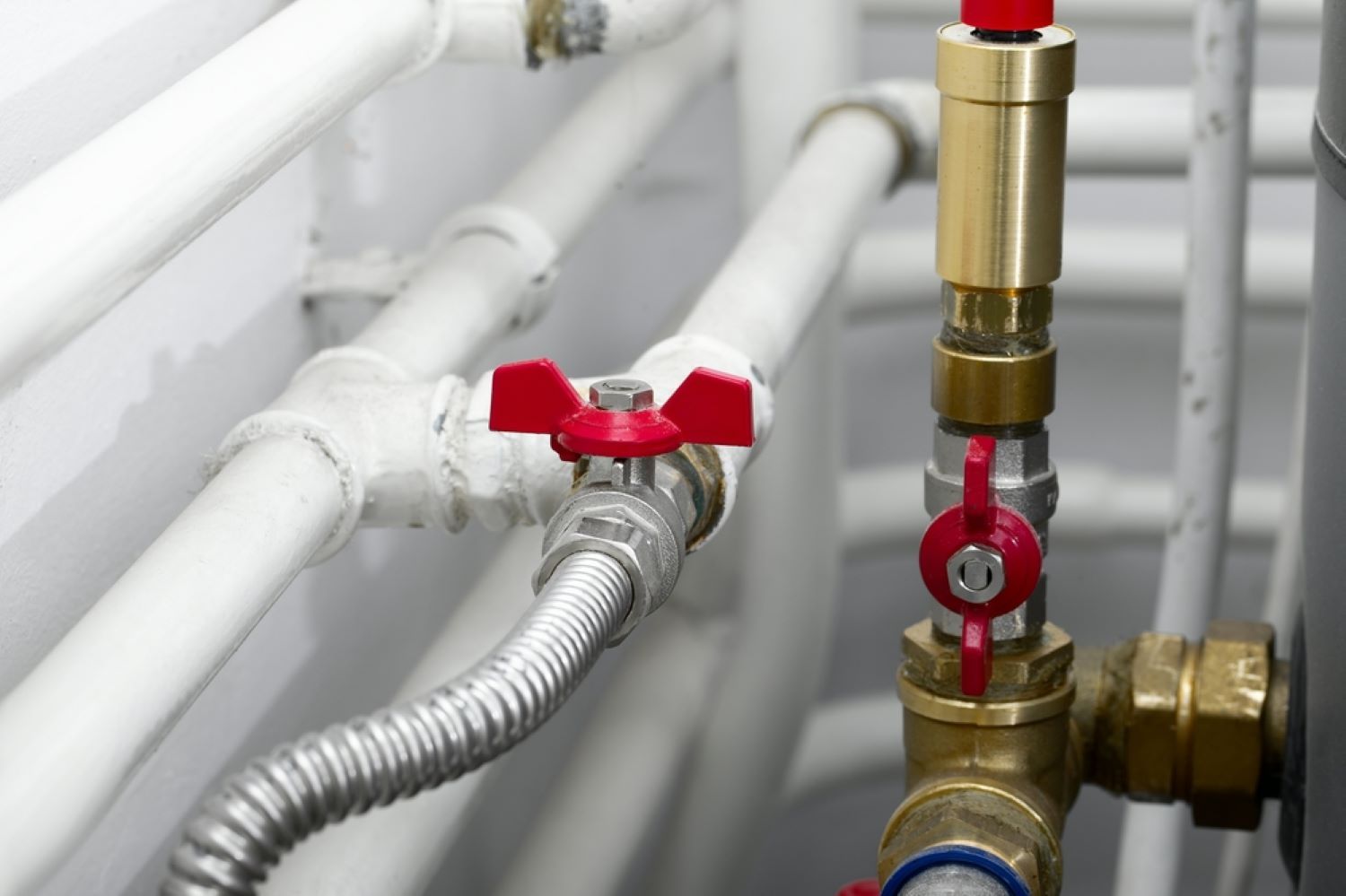 A Close up Of a Water Pipe with A Red Valve — Coffs Coast Plumbing in Korora, NSW