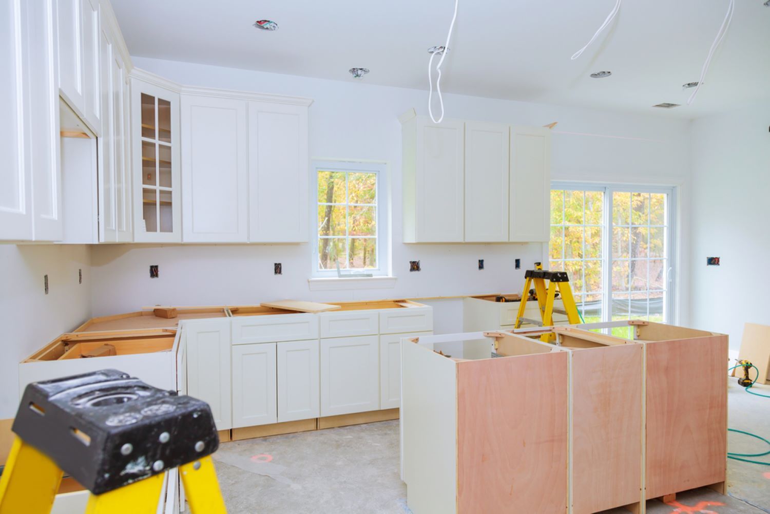A Kitchen Under Construction with White Cabinets — Coffs Coast Plumbing in Moonee Beach, NSW