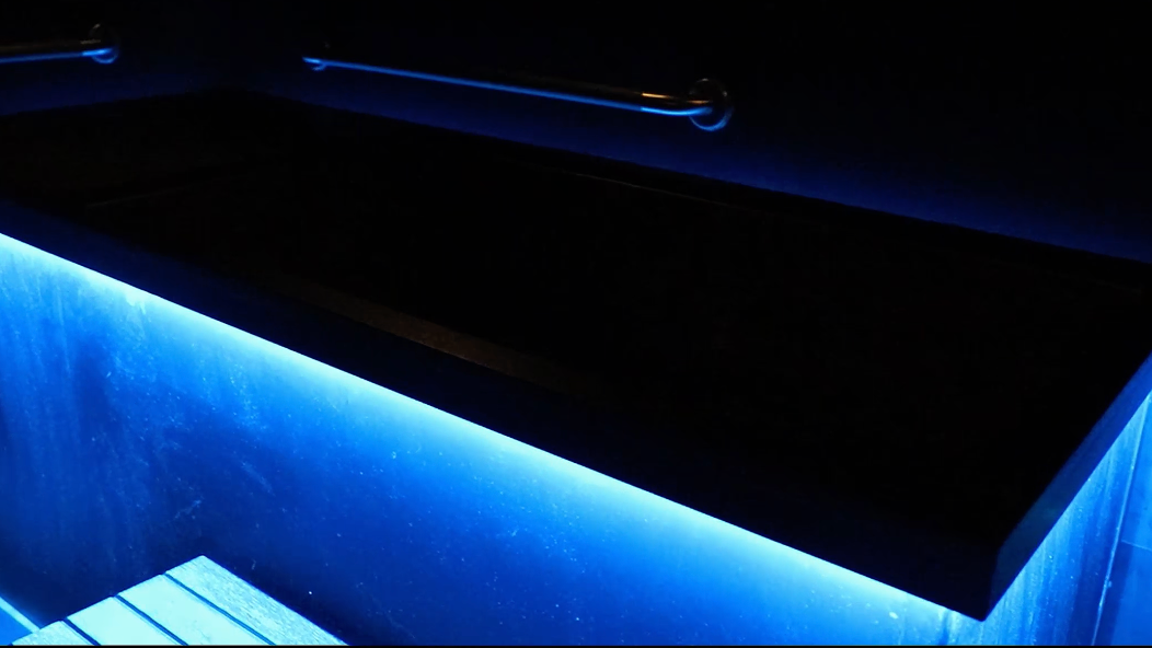 A blue light is shining on a black surface