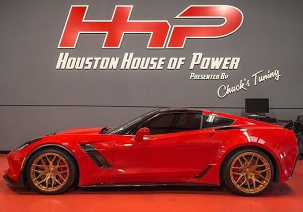 Sports car in front of the Houston House of Power inside shop sign  | Houston House of Power