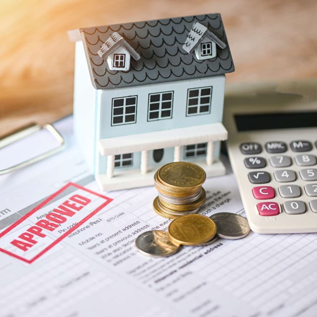 A small model house alongside coins, a calculator, and an approved loan document, symbolizing the finance and appraisal deadline to protect a buyer's earnest money.