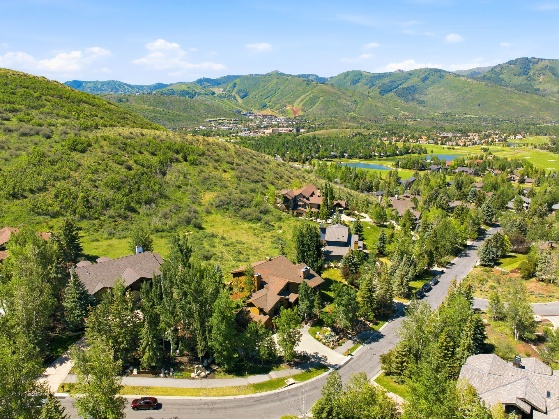 Aerial drone view capturing panoramic ski resort vistas and the Fairway Hills landscape from the property.