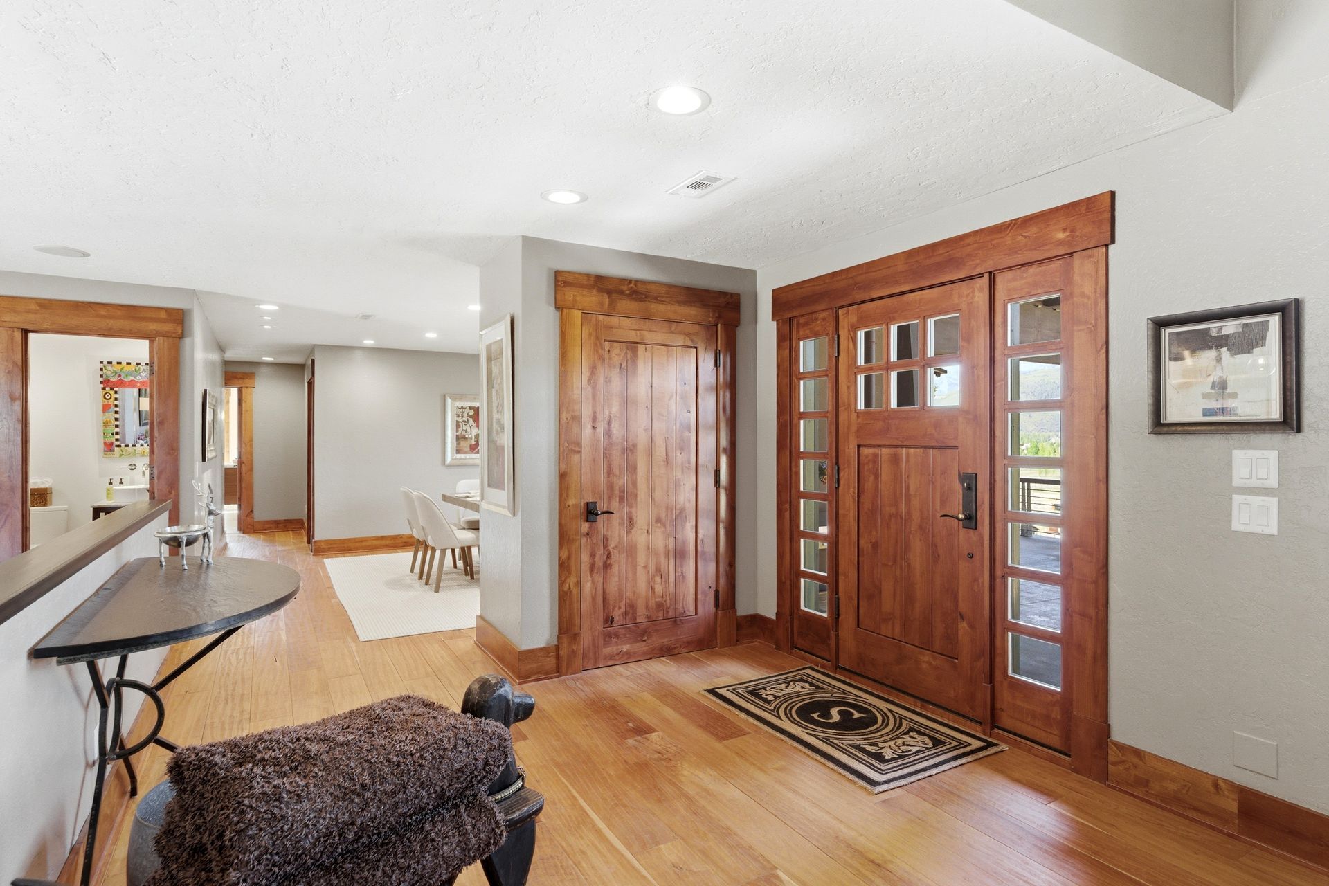 Welcoming front entryway with a solid wood door and hand-scraped cherry hardwood flooring at this Old Ranch Road luxury home.