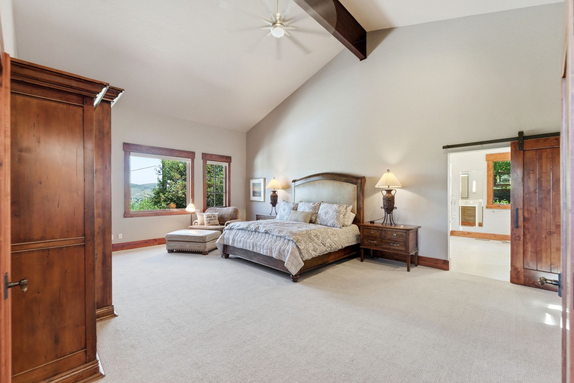 Luxurious main-level primary suite featuring high gable ceilings in this Park City mountain estate.
