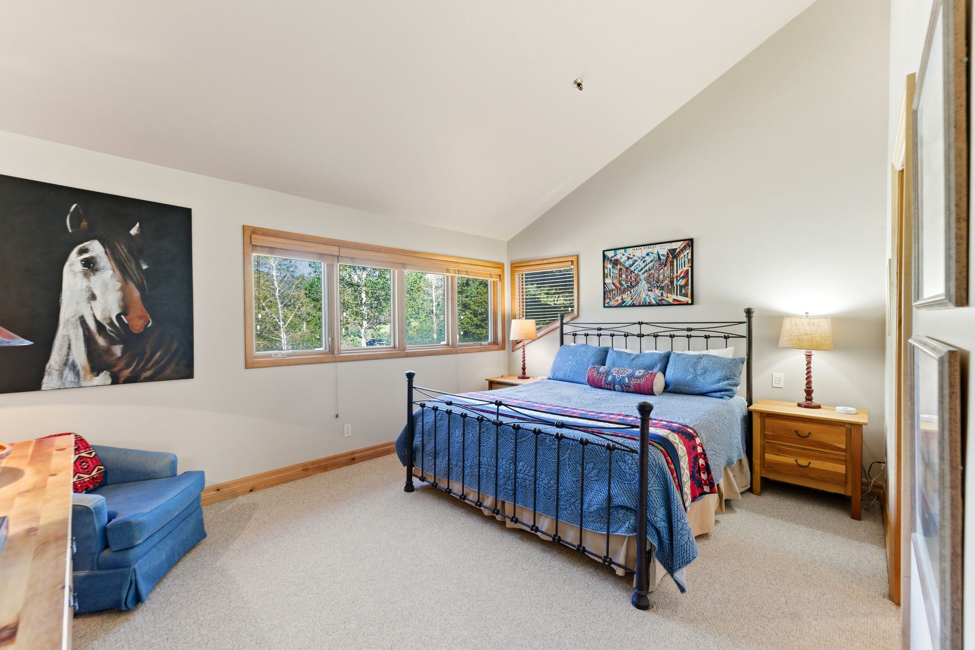 Spacious primary suite featuring large windows that bring in natural mountain light.