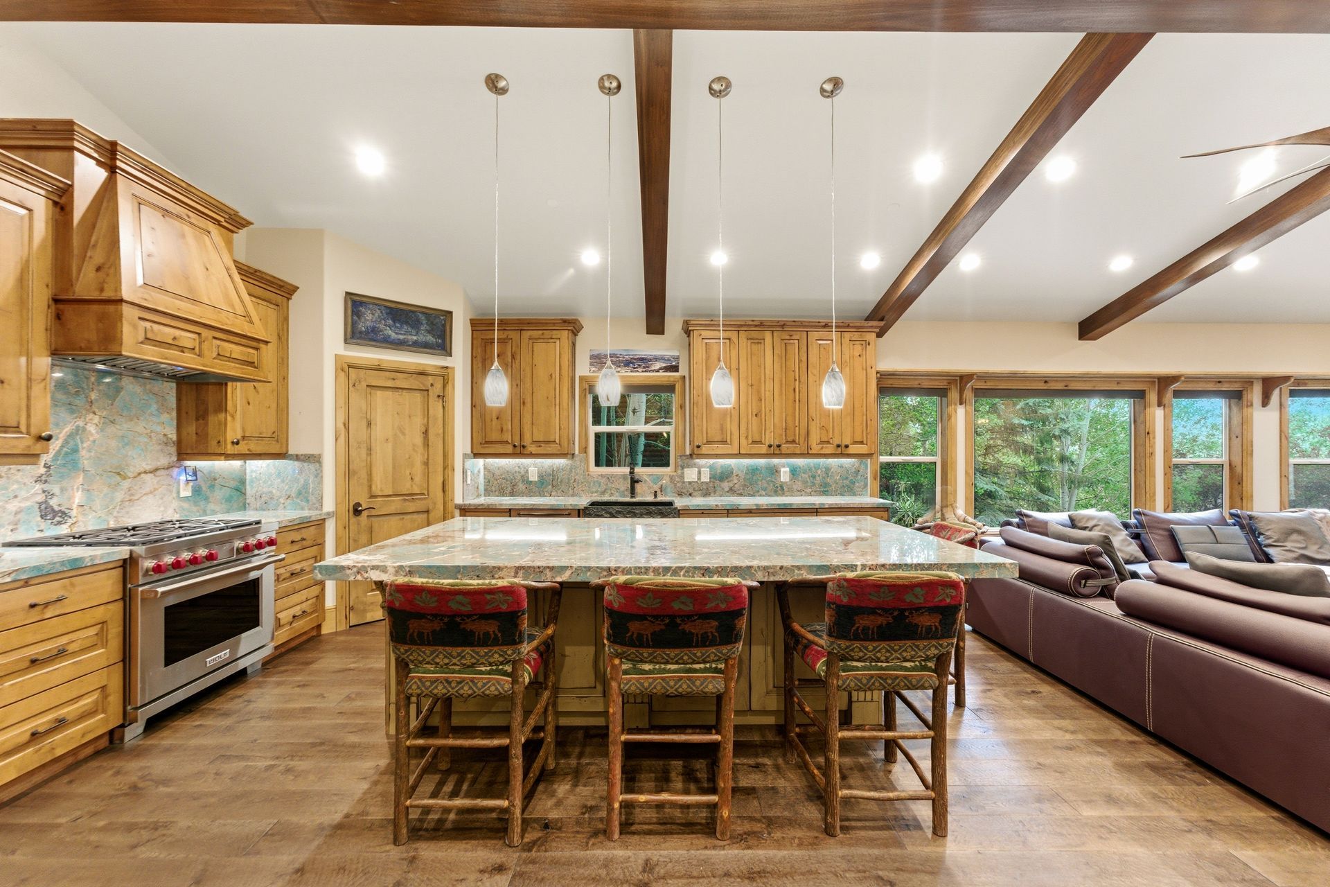 True chef's kitchen featuring custom alder cabinetry and rare Amazonite quartzite countertops in this Deer Mountain retreat.