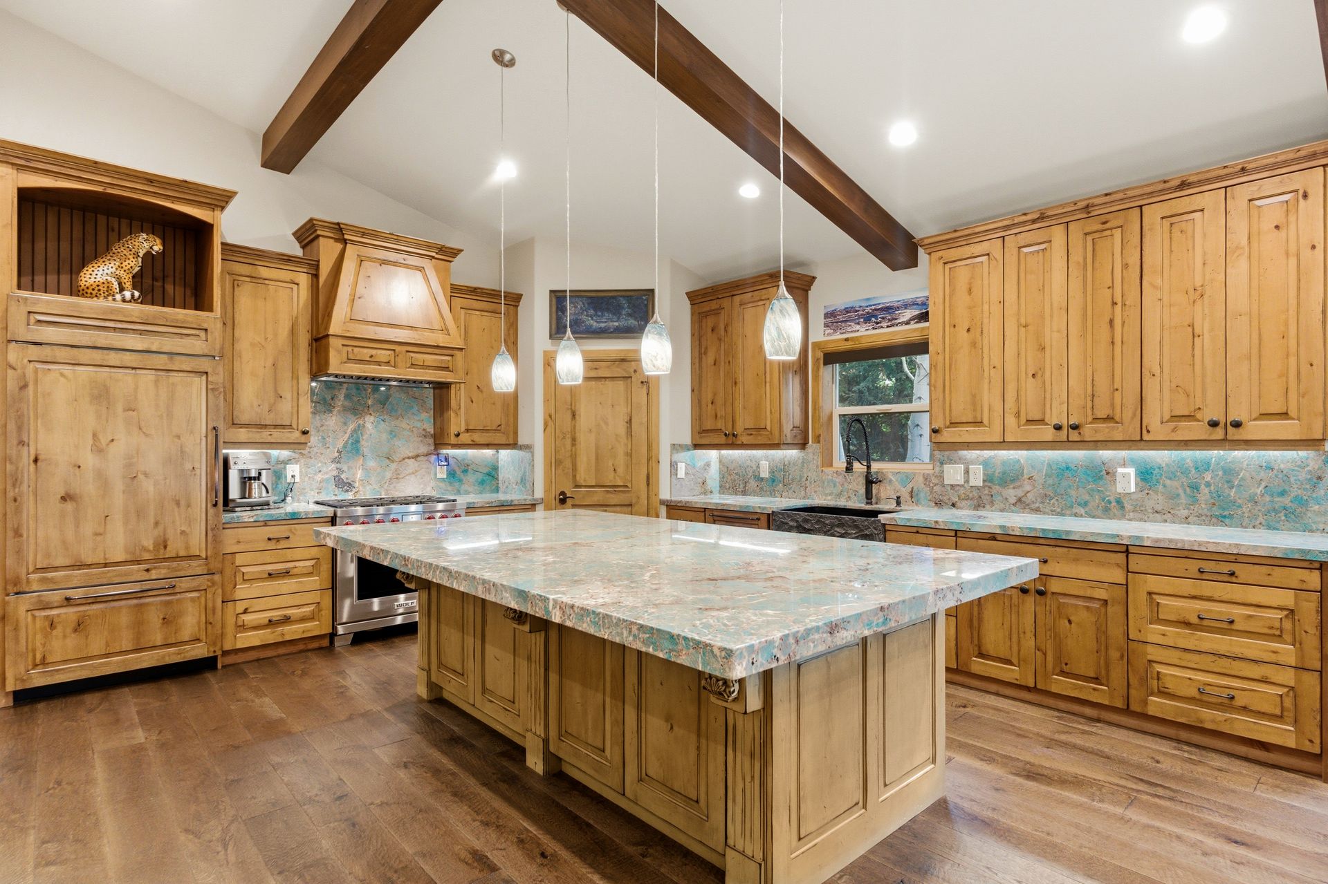 True chef's kitchen featuring rare Amazonite quartzite countertops and premium Wolf appliances in this Park City area mountain home.