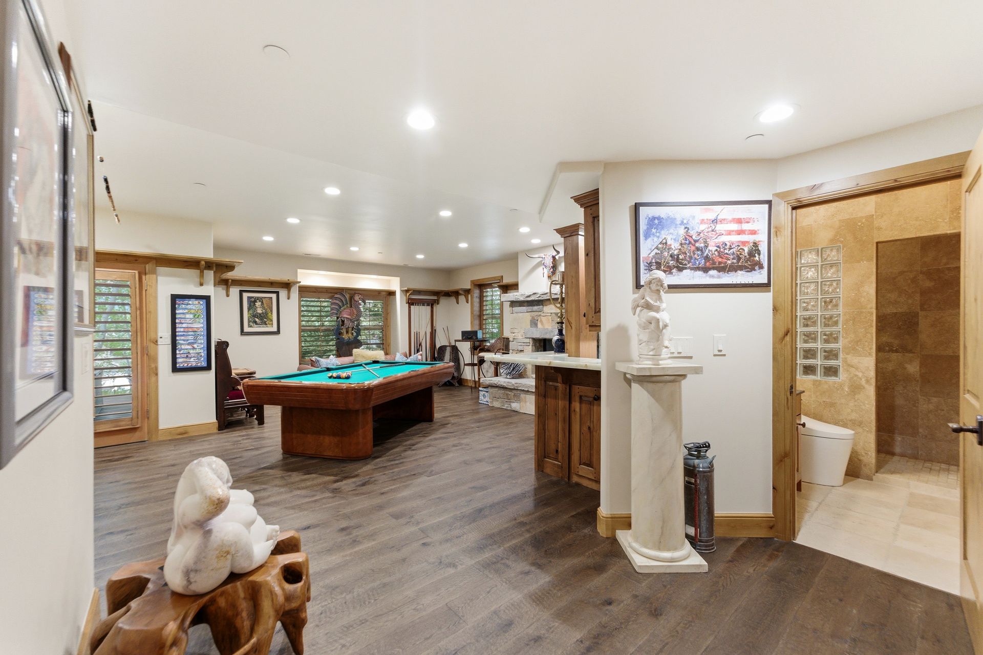 Walk-out lower-level living area showing the entrance to the guest bathroom in this Deer Mountain retreat.