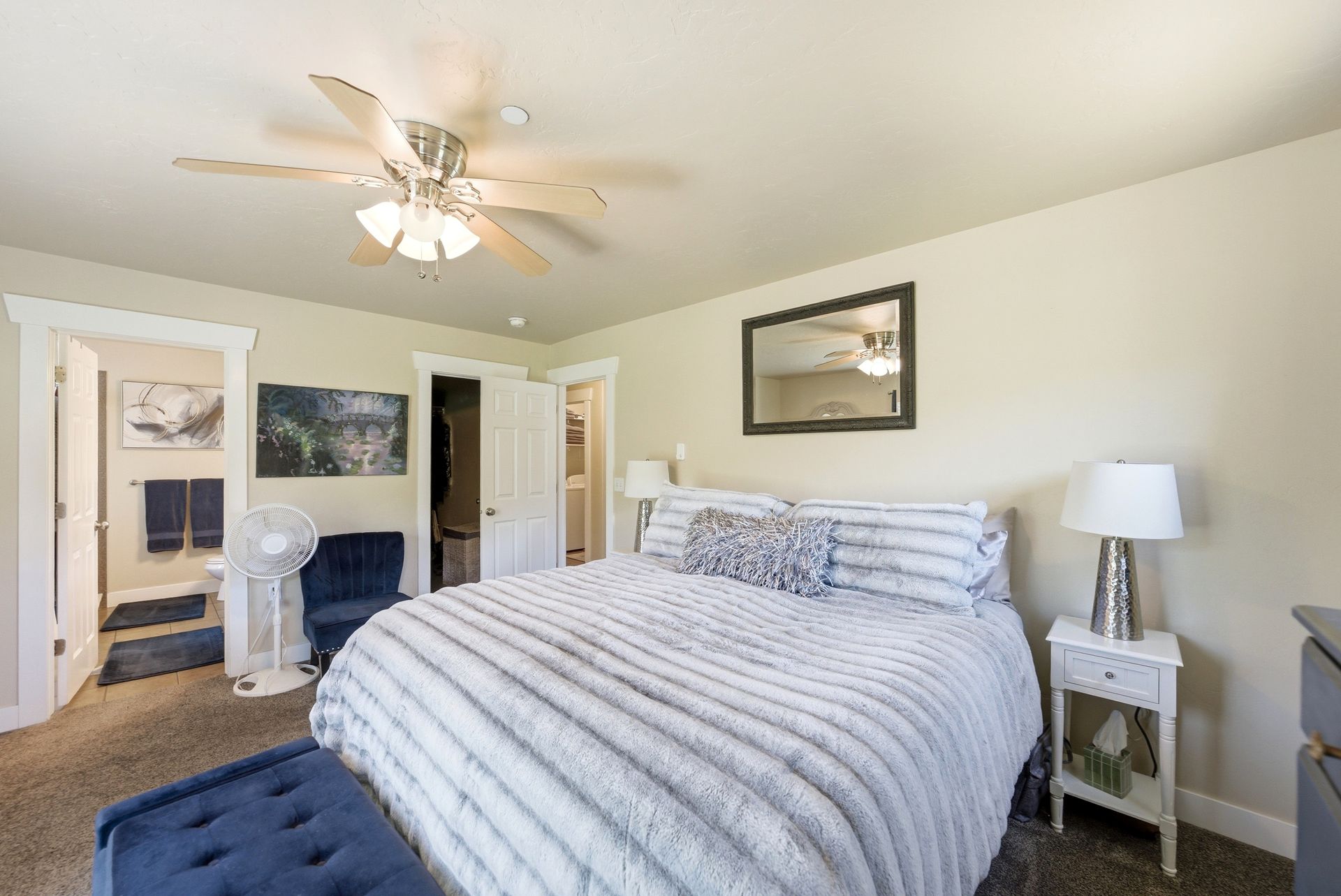 Spacious upper-level primary suite showing the seamless flow into the en-suite bathroom and hallway in this Timber Lakes home.