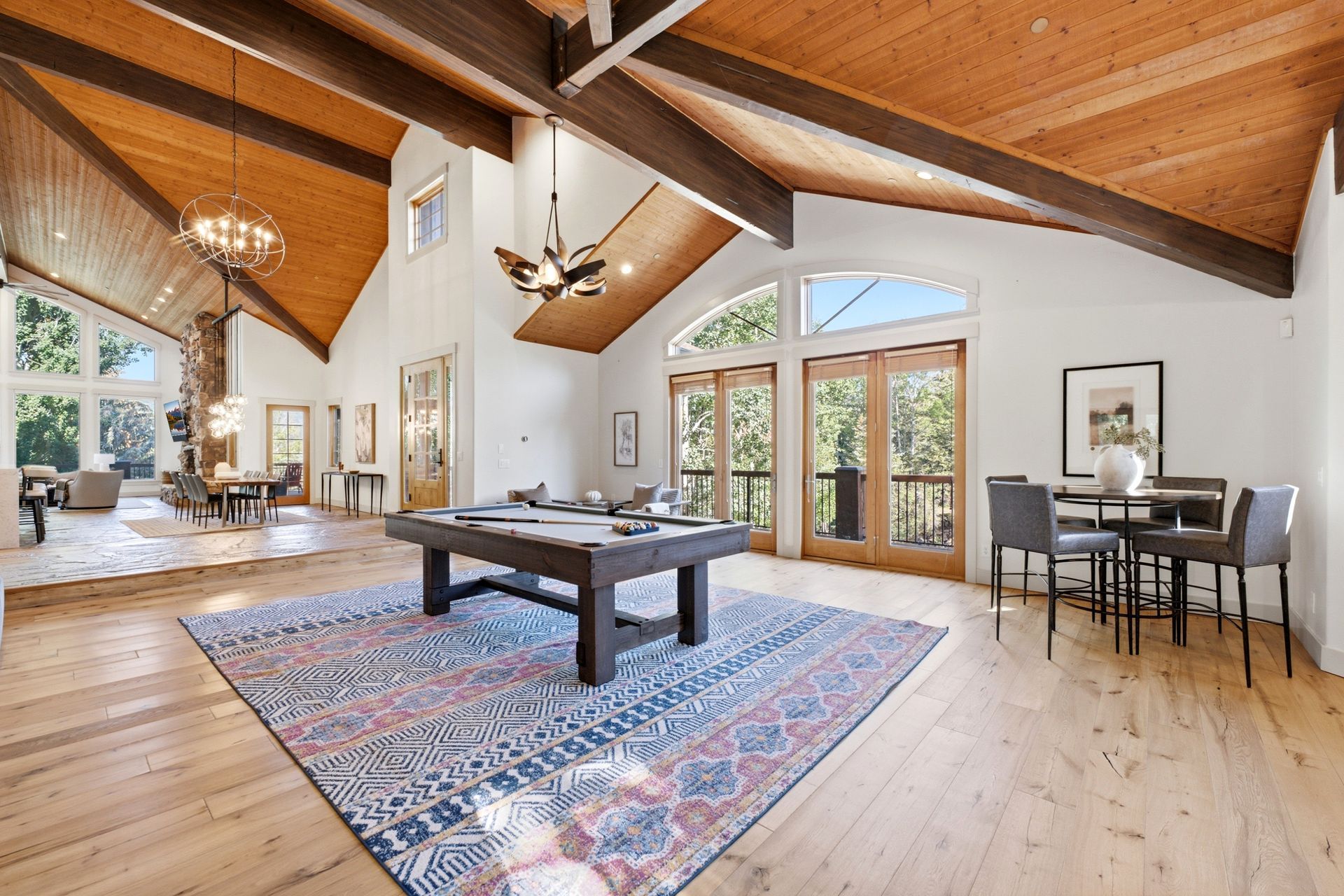 Great room at 2490 Silver Cloud Dr with pool table, vaulted wood ceiling, and view toward the dining area