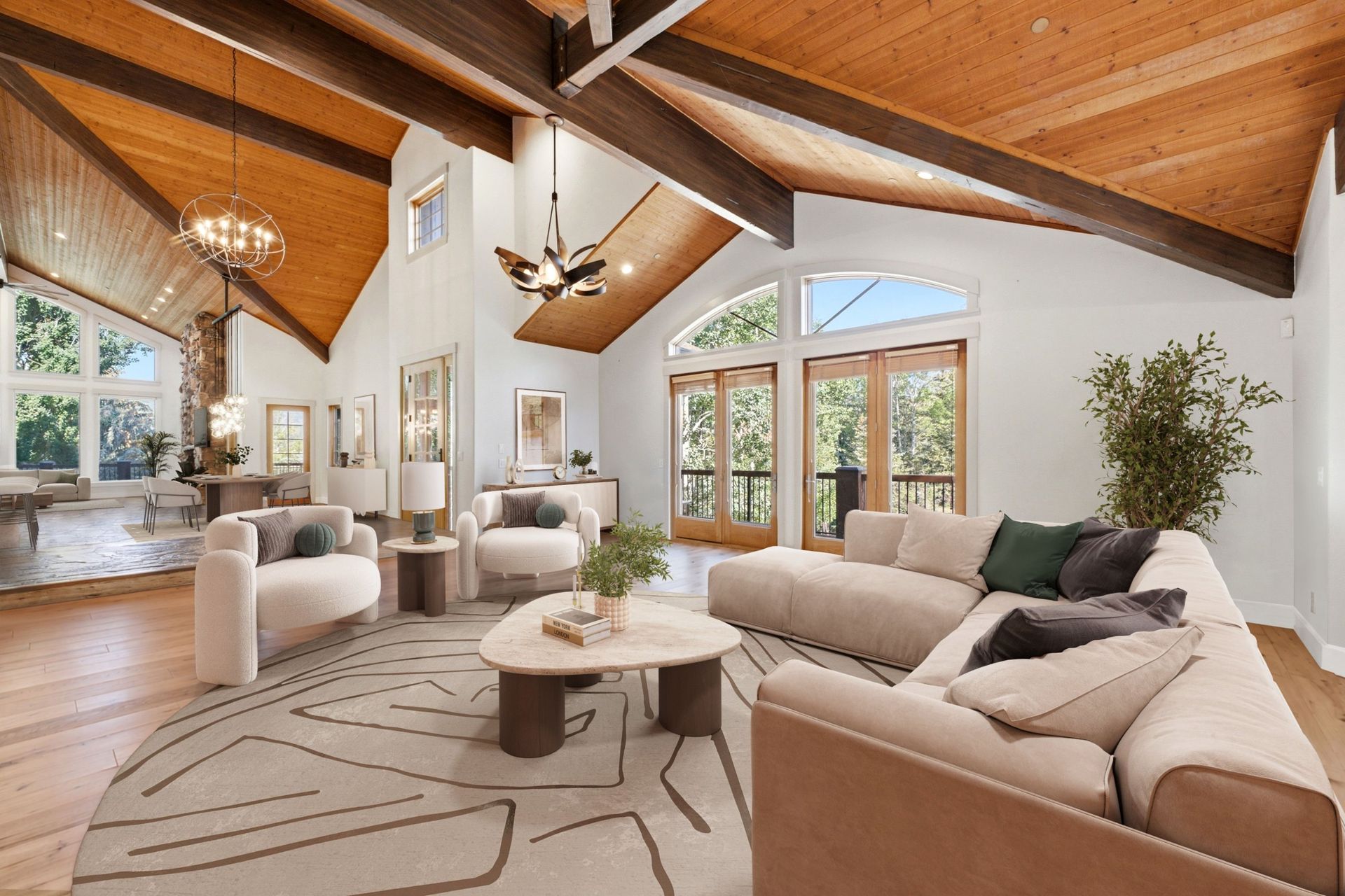 Virtually staged great room at 2490 Silver Cloud Dr with sectional sofa, accent chairs, and vaulted wood ceiling