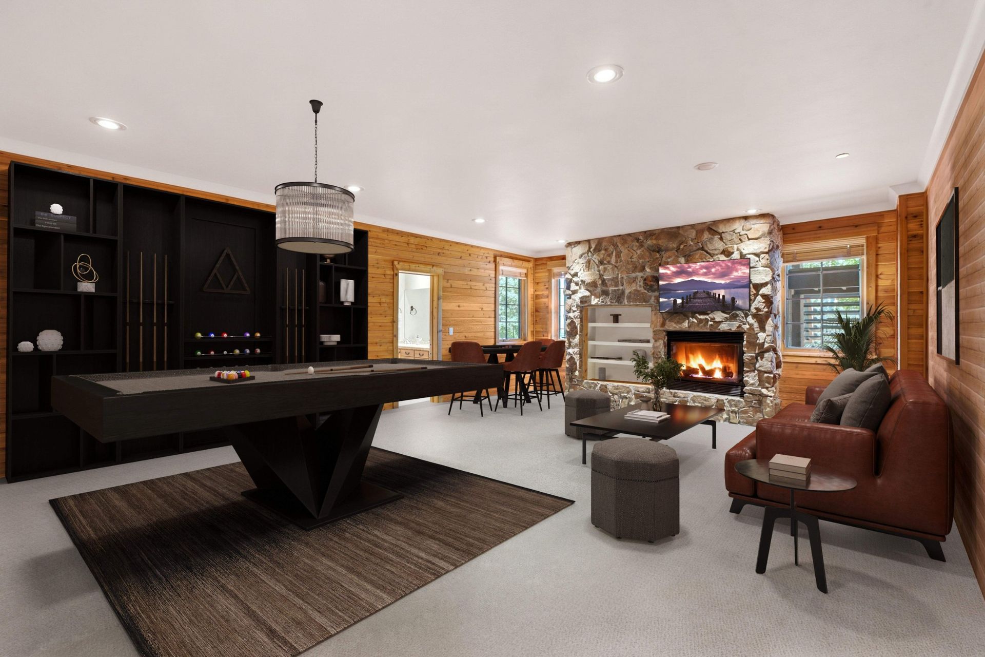 Virtually staged lower level game room at 2490 Silver Cloud Dr with pool table, black built-ins, and stone fireplac