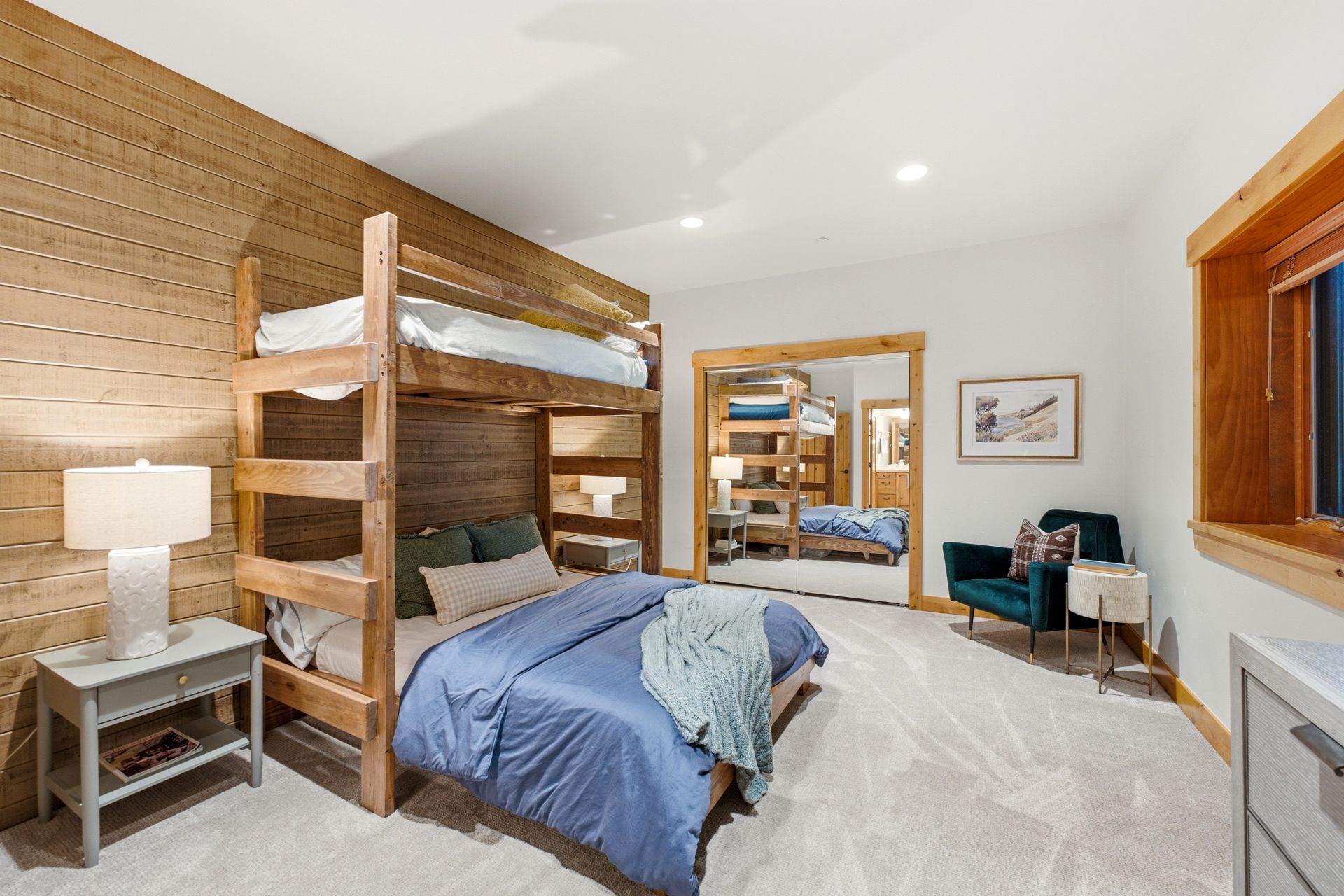 Guest bedroom featuring warm wood accents and abundant natural light at the 2490 Silver Cloud Drive estate.