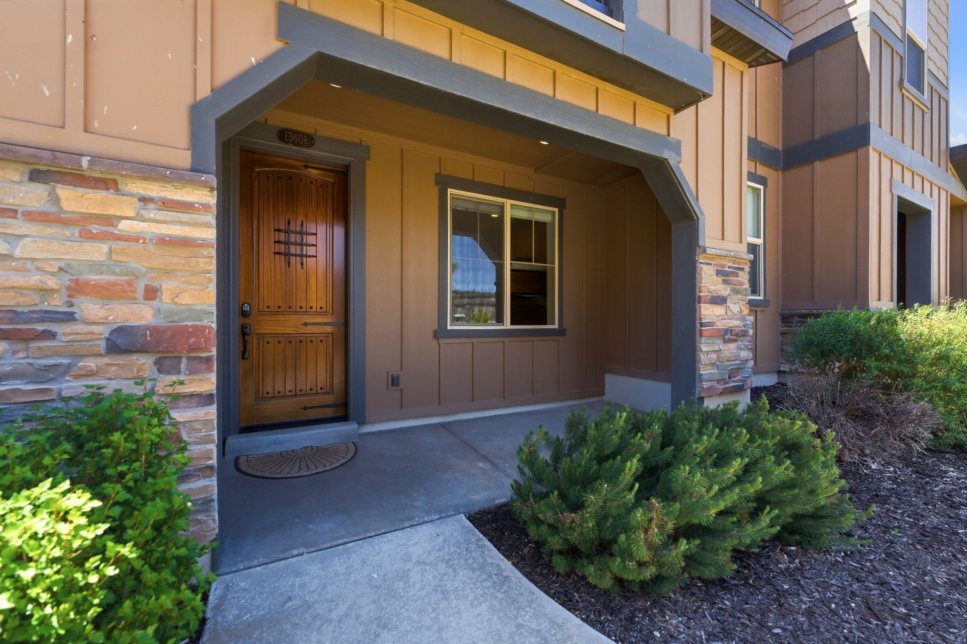 Front entrance and exterior details of the Park's Edge townhome at 13608 N Hillclimb Lane.