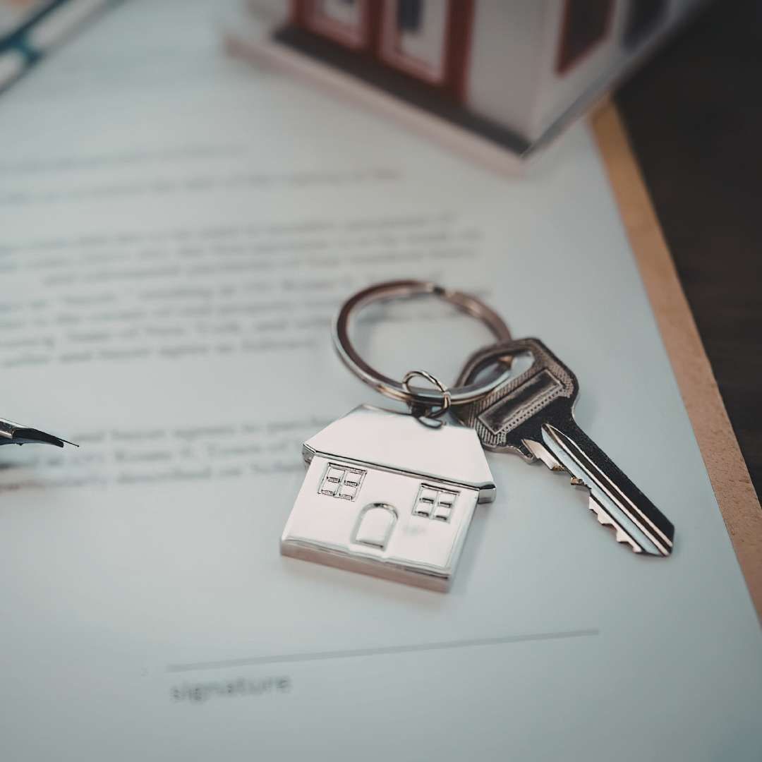 House keys with a house-shaped keyring resting on a real estate contract ready for signature, representing the seller's disclosure deadline for a Park City homebuyer.