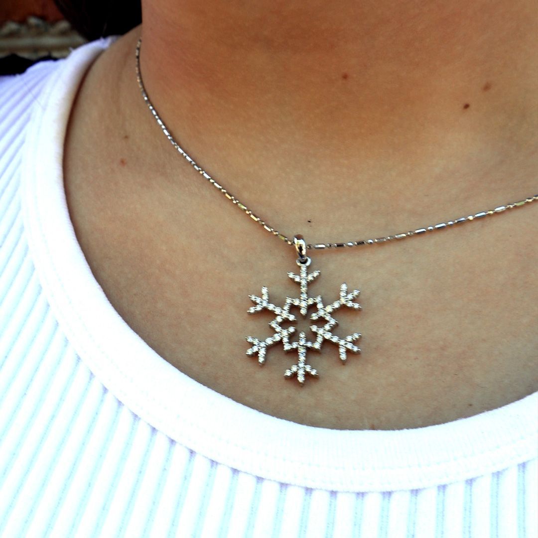 A close-up of a custom diamond snowflake pendant crafted by Park City Jewelers.