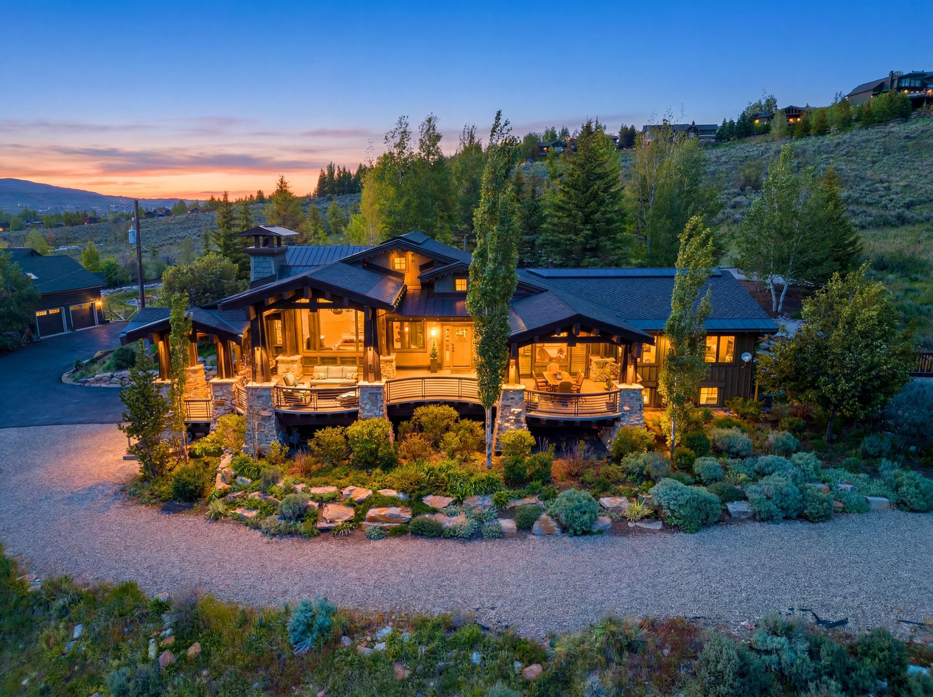 Twilight exterior view of the luxury 5,056 sq ft mountain estate at 5478 Old Ranch Road in Park City, Utah.