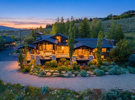 Twilight exterior view of the luxury 5,056 sq ft mountain estate at 5478 Old Ranch Road in Park City, Utah.