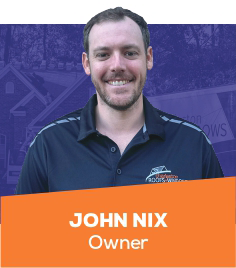 Portrait of John Nix, owner, in a navy shirt with orange name banner.