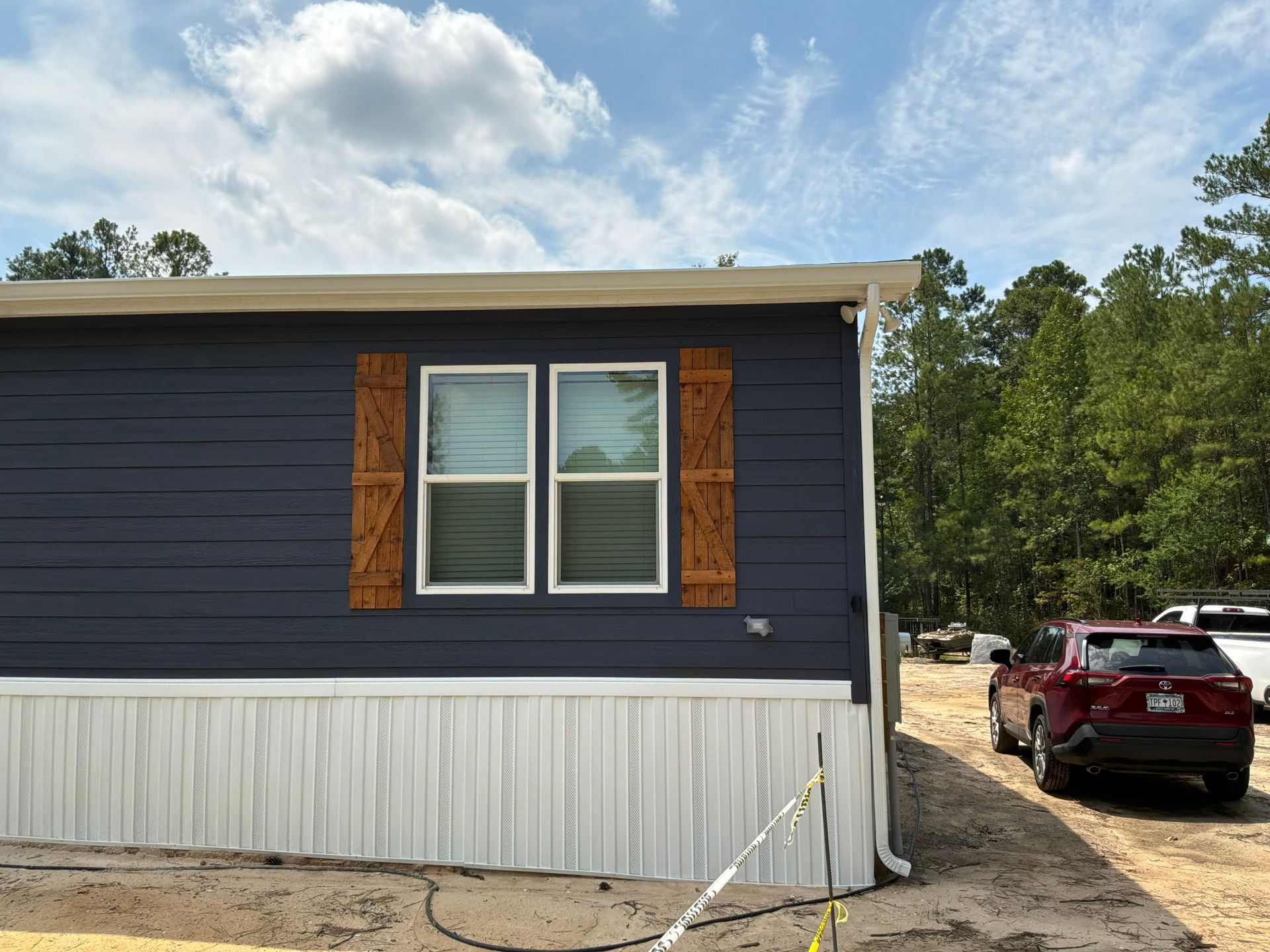 Finished gutter profile following the eave line of a traditional Lowcountry home by Charleston Roofs and Windows