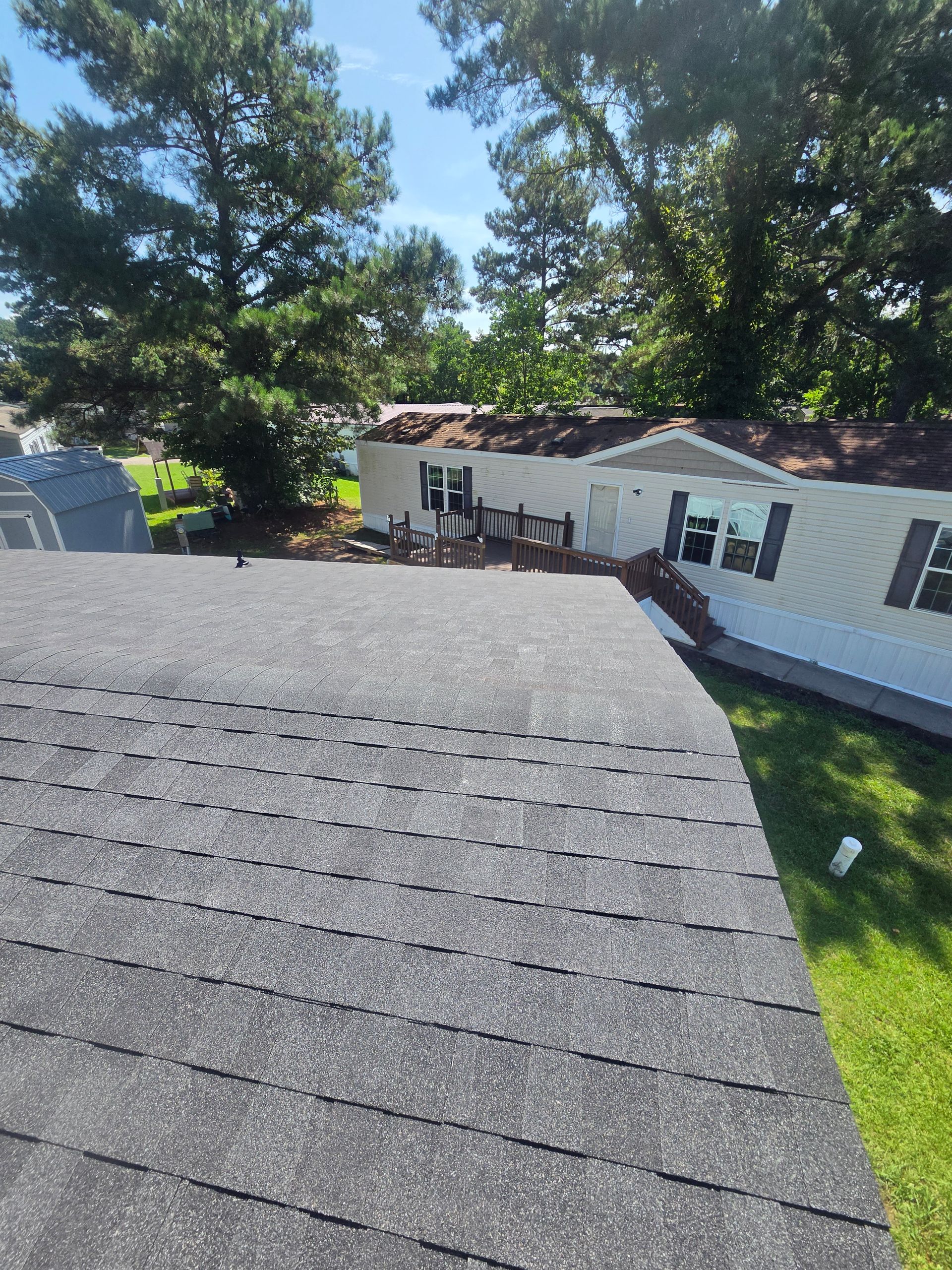A collage of finished Charleston Roofs and Windows projects around North Charleston SC with five-star review cards overlaid: a one-day roof replacement on a Park Circle cottage, new Viwinco windows on a 1970s home, an emergency tarp after a pine limb fell, and new seamless gutters. The image represents the 680 Google reviews averaging 4.9 stars that homeowners have left for Charleston Roofs and Windows.