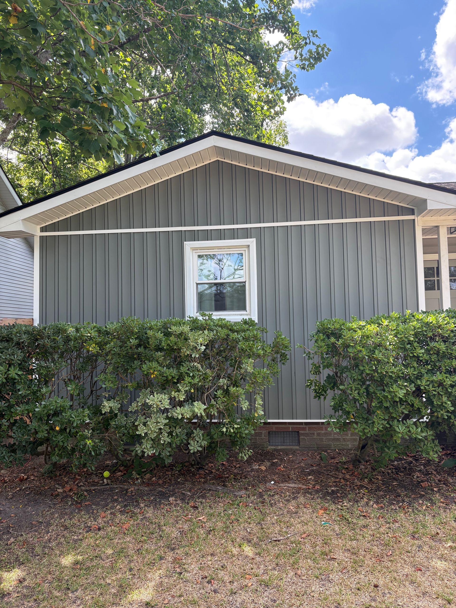 New white corner boards, window trim and vented soffit on a Charleston home by Charleston Roofs and Windows