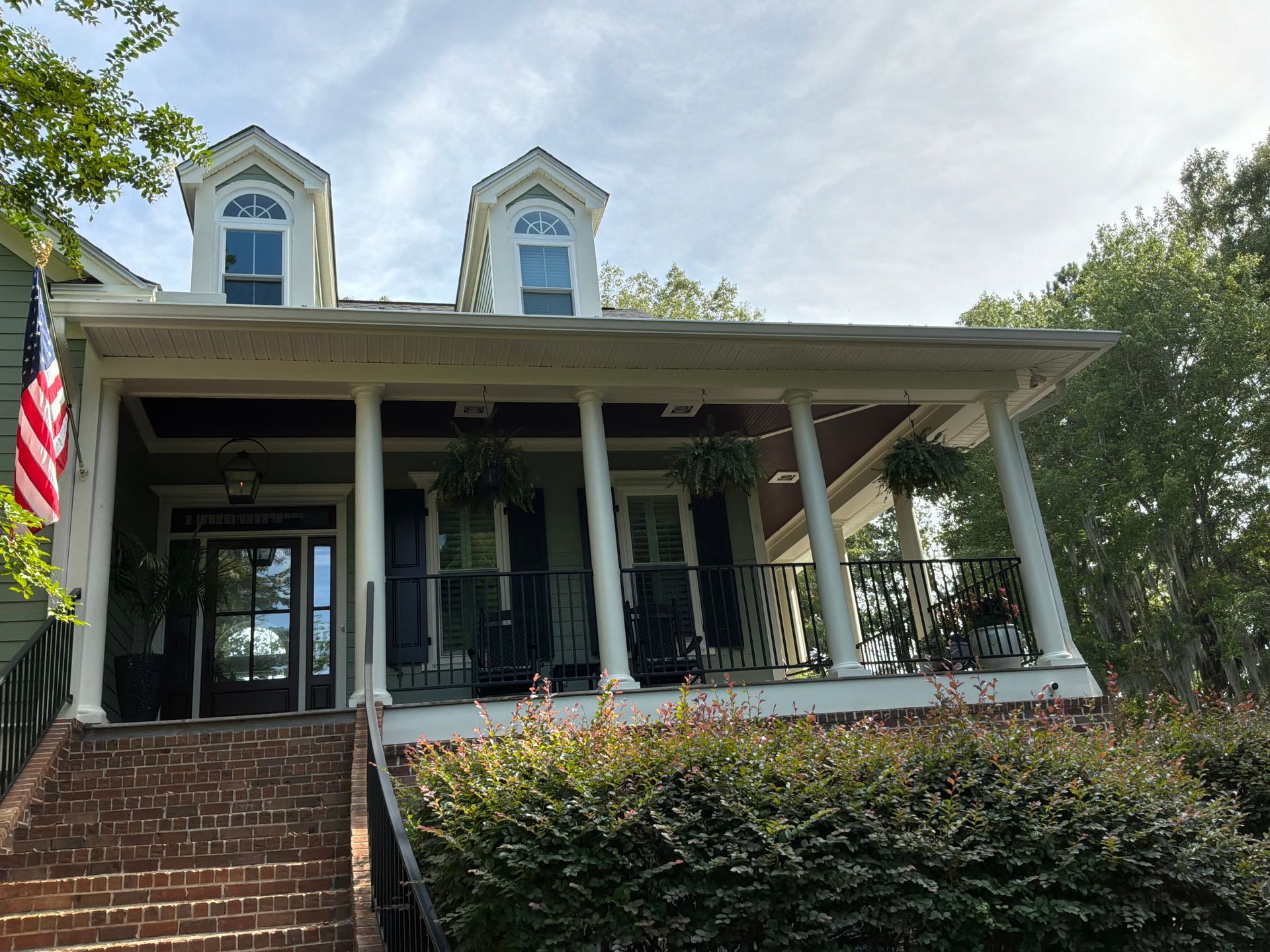 A row of Sullivan's Island homes photographed by Charleston Roofs and Windows: a 1890s officers' quarters house on I'On Avenue with a metal roof, a raised Atlanticville island cottage on Middle Street, a post-war ranch near the marsh and a large newer elevated beach house toward the east end. The photo represents the mix of historic, post-Hugo and modern homes on Sullivan's Island and the roof each one needs.