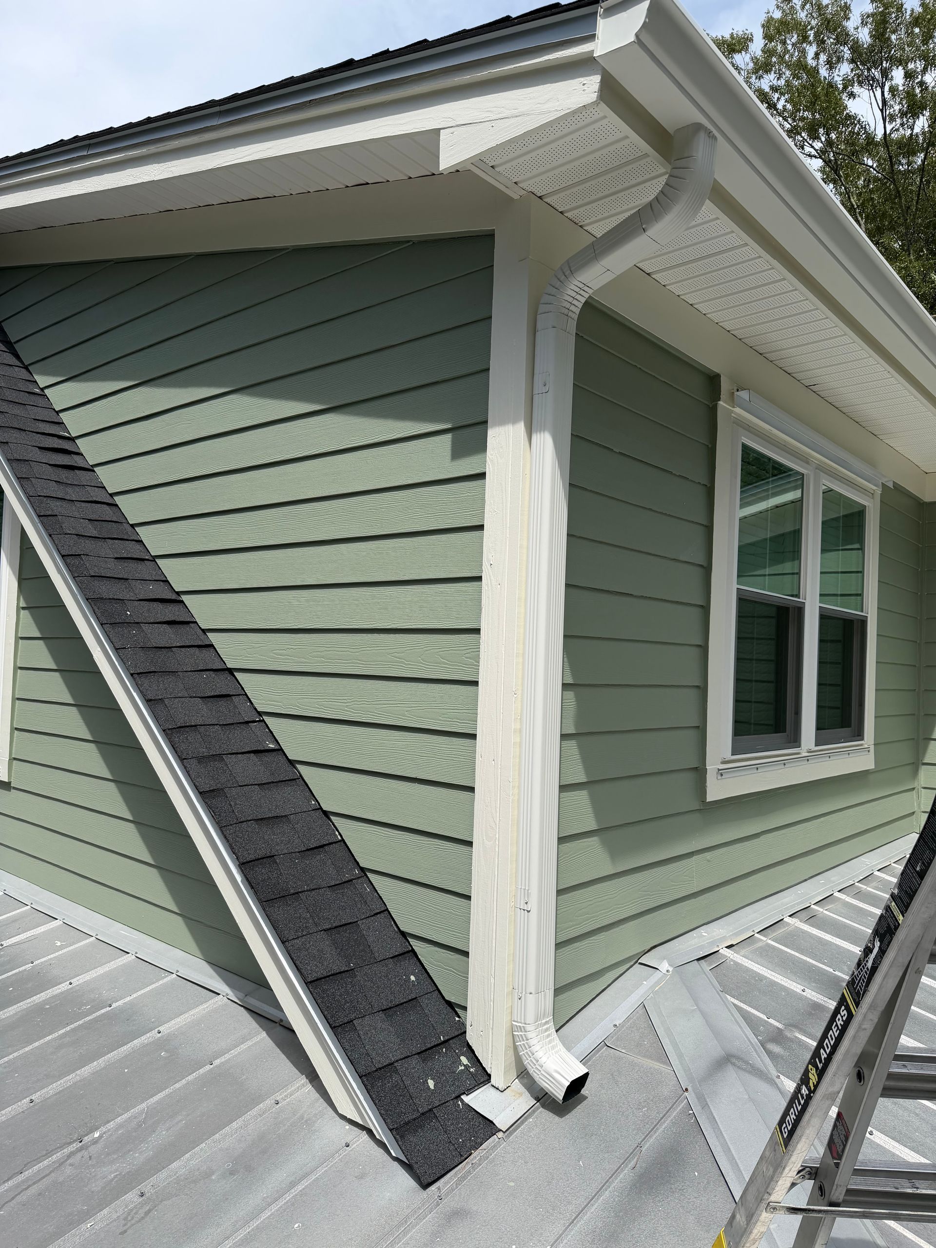 A Charleston Roofs and Windows inspection manager reviewing a line-item roof replacement estimate with a Seabrook Island homeowner on a screened porch over the marsh, with a SIPOA ARC application and shingle color board on the table. The image represents roof replacement cost on Seabrook Island, SC, priced per square for shingle, metal and flat roofs, with free inspections and 0% financing on approved credit.