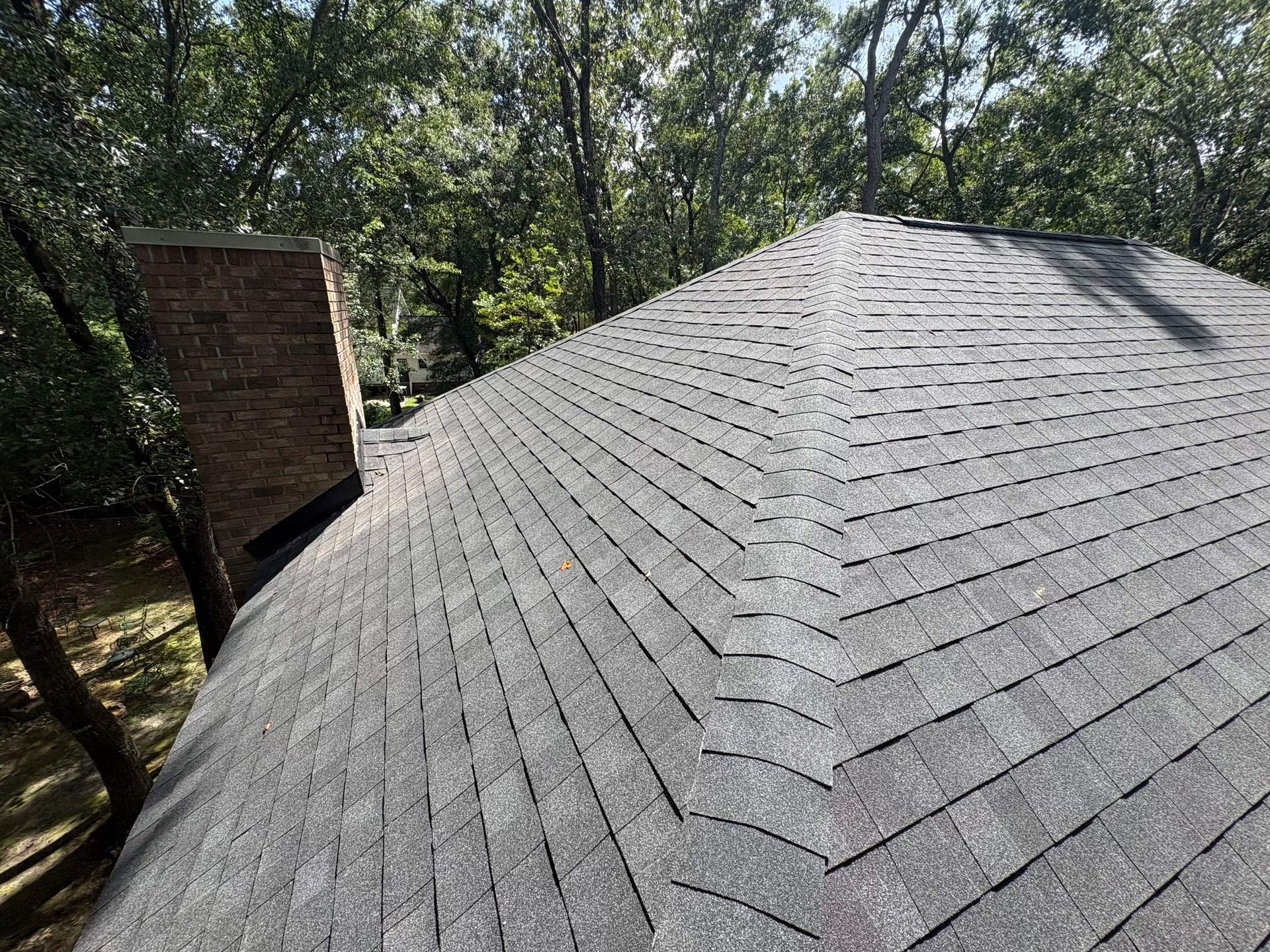 Roof replacement near you crew protecting landscaping before tear-off on install day
