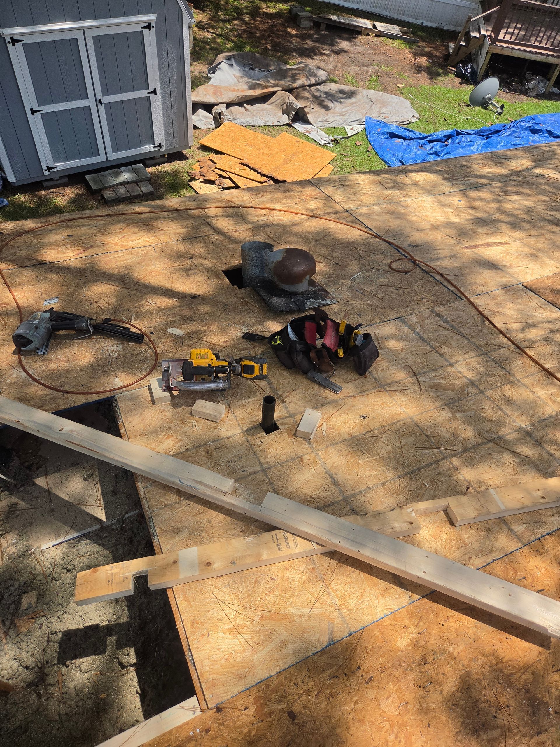 Roof inspection near you inspection manager photographing a ridge cap on a shingle roof