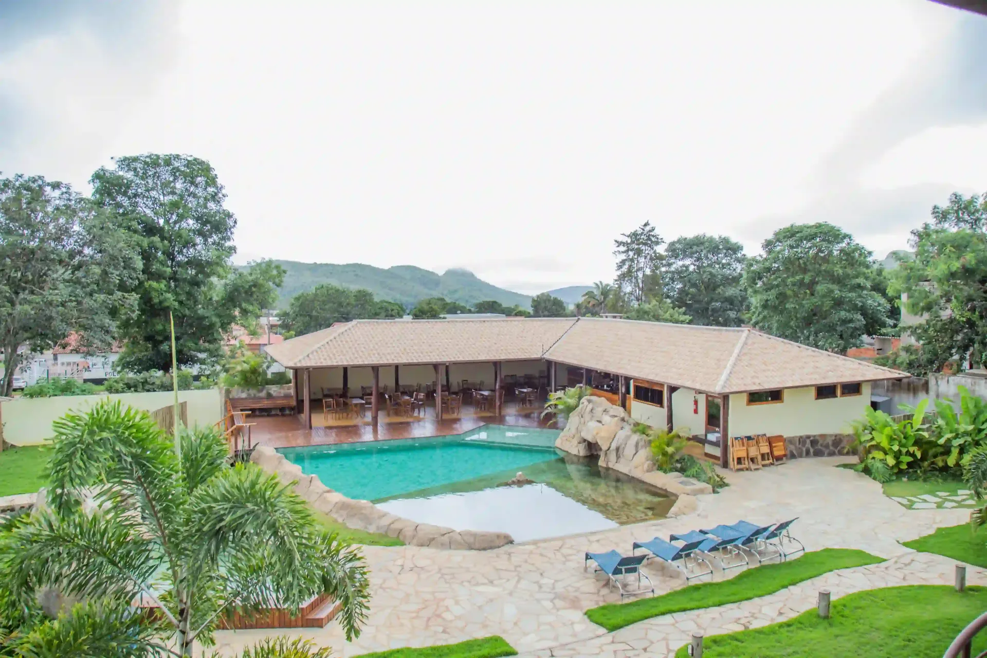 Há uma grande piscina no meio do quintal. pousada-dos-guias