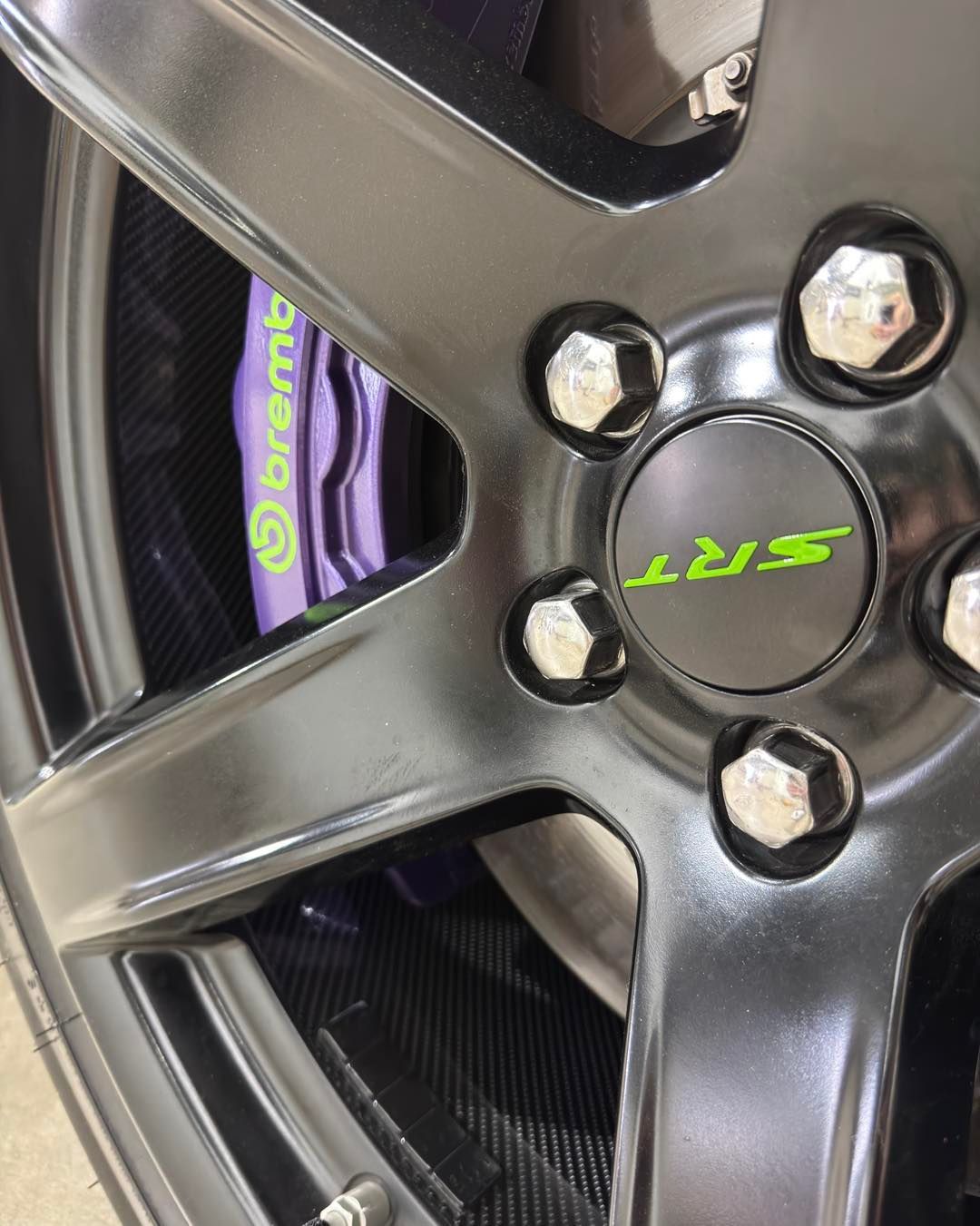 Close-up of a black alloy car wheel with a visible Brembo brake caliper