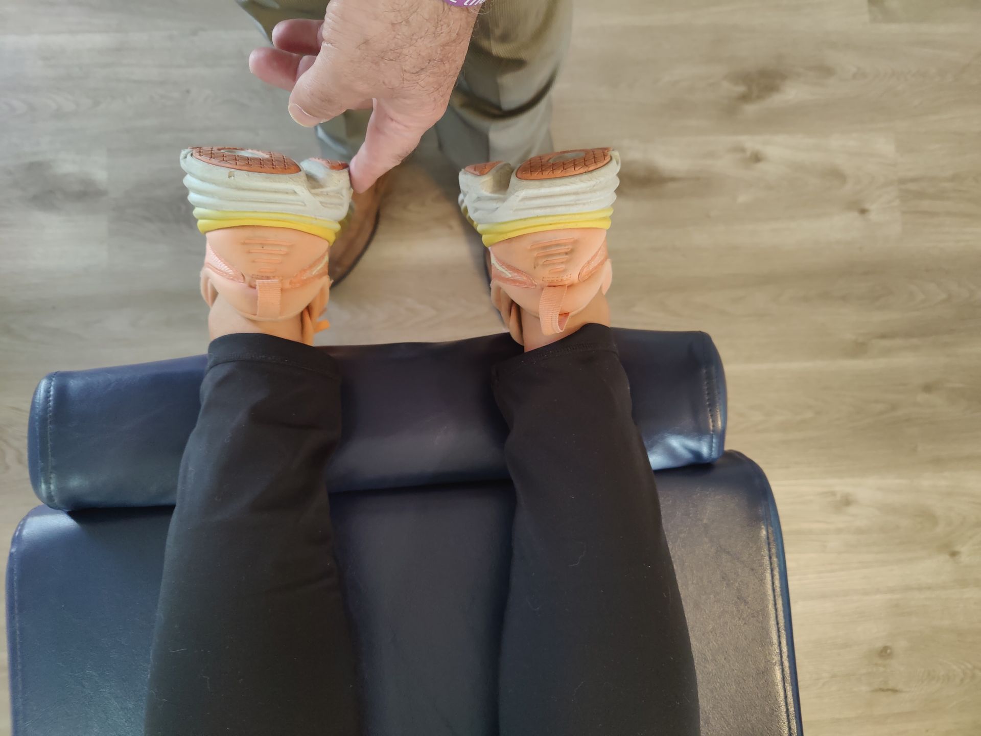 A person is sitting on a chair with their legs crossed.