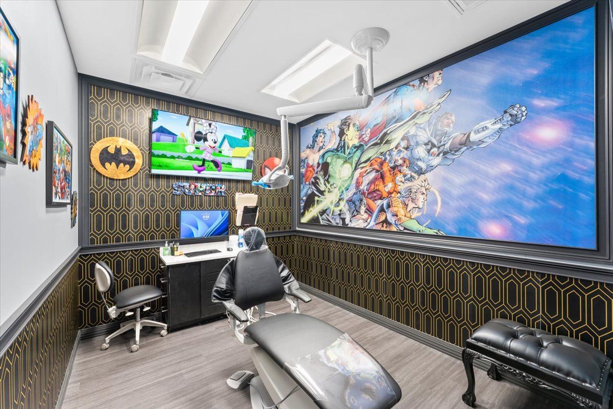 Super Dentists in San Antonio A dental office with a dental chair and a large mural on the wall.