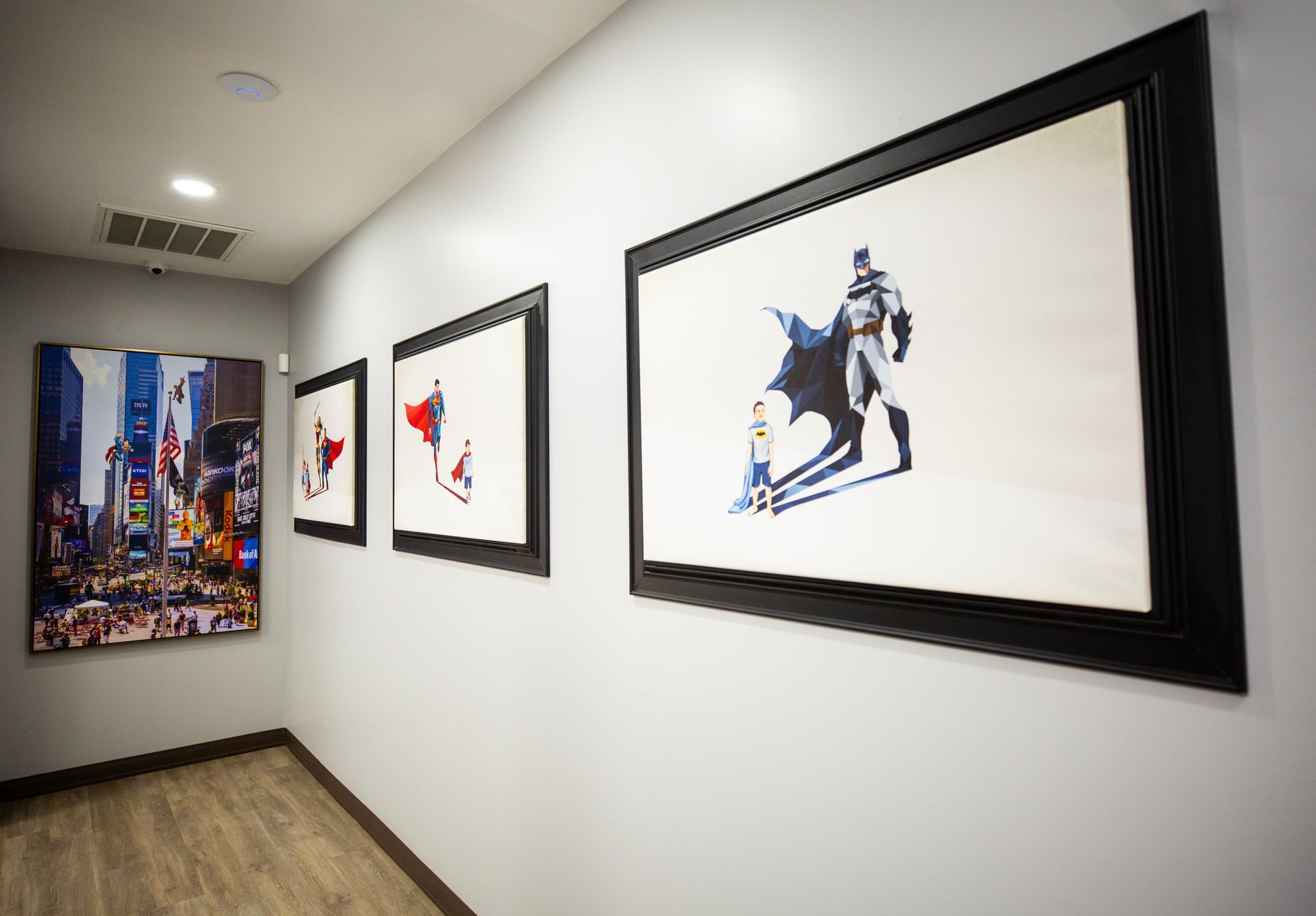 Super Dentists in San Antonio A hallway with paintings of batman and superman on the wall.