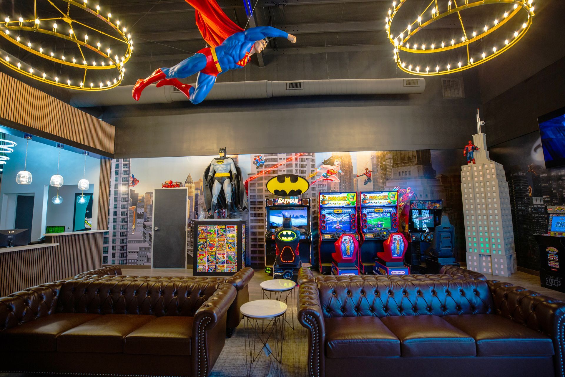 Super Dentists in San Antonio A room with a couch , chairs , and a statue of superman hanging from the ceiling.